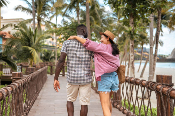 Interracial Couple Enjoying Seaside Promenade Stroll