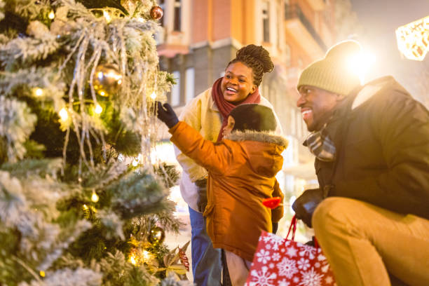 istock Family Decorating Christmas Tree at Night 2173973015