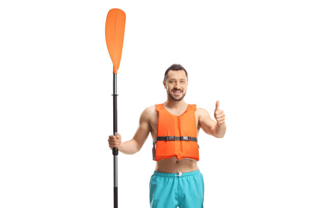 istock Young man with a life vest and a paddle gesturing a thumb up sign 2173973098