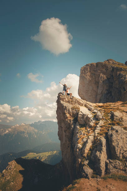 istock Young women hikers stand on cliff above valley 2173974289