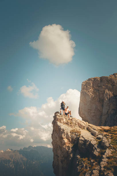 istock Young women hikers stand on cliff above valley 2173974292