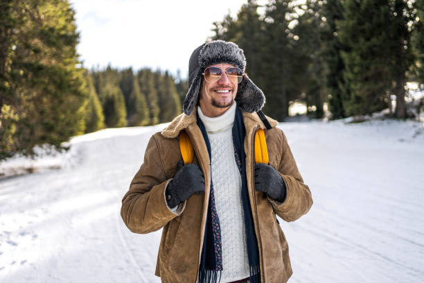 istock Young smiling man on the mountain on a snowy winter day 2173975113