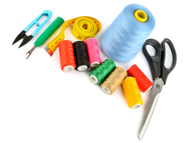 istock Sewing supplies (thread, scissors and measuring tape) isolated on a white. Free space for text. 2173975701