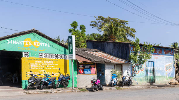 A sidewalk fresh fruit stand with all of the needs for the local population in one stop. Fresh tropical fruits, bread and vegetables just waiting to be bought by the local villagers