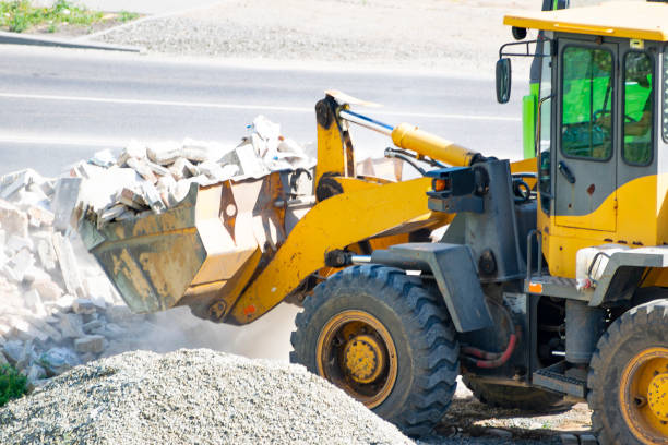 istock removal of construction waste with a bulldozer. loading into a dump truck. close-up 2173978068
