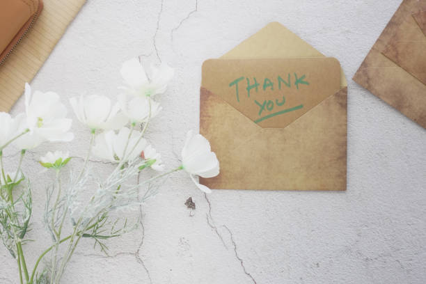 istock thank you message and envelope on wooden table 2173978595