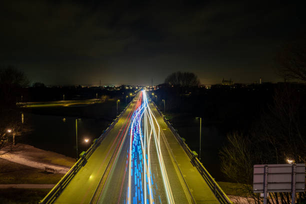 istock Colorful light trails creating dynamic lines on bridge at night 2173979010