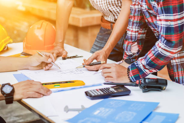 istock Blurred image, engineer is giving advice and consulting with the designer to find out construction site where engineer will have to construct the project. Consultation between engineers and designers 2173980083