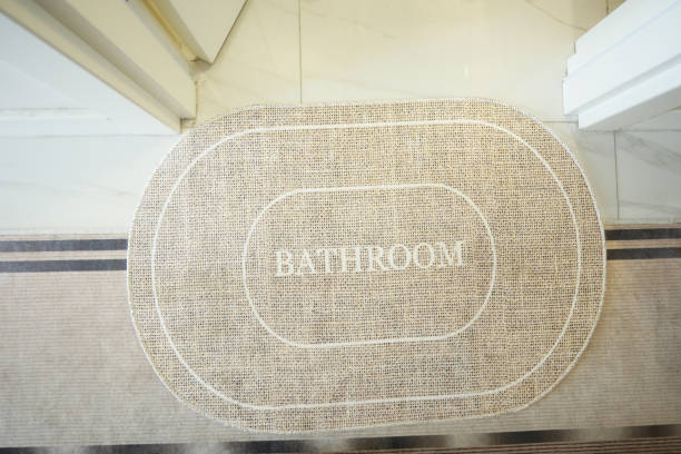 istock A bathroom mat placed on a clean tiled floor, creating a welcoming and cozy environment in the room 2173980103