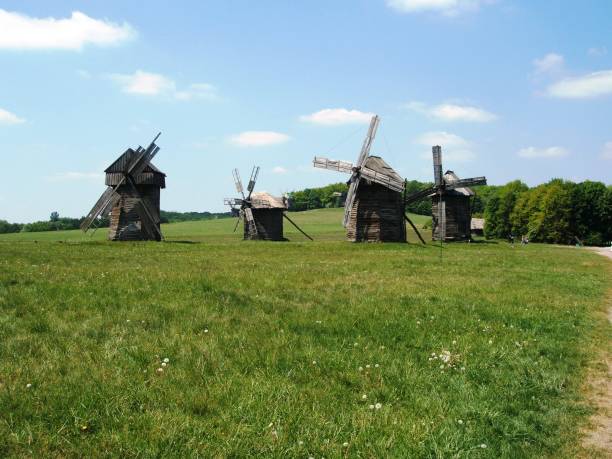 istock Windmills Amidst Green Nature: A Refreshing Contrast Against a Blue Sky 2173987218