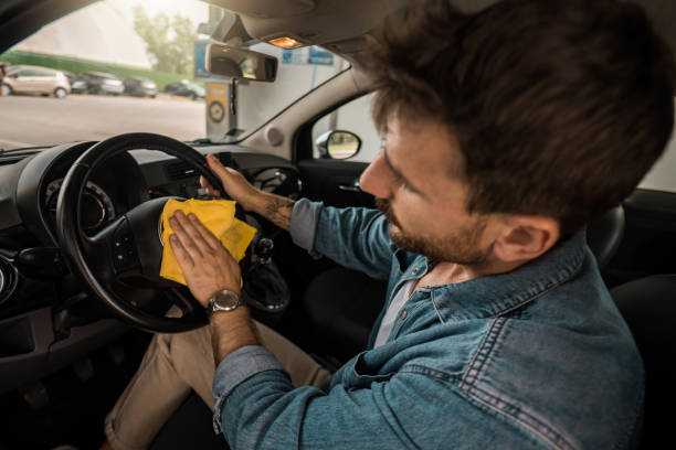 istock Young man wiping his car interior. 2173987576