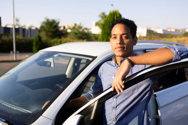 Portrait of a Middle Eastern mid adult man standing by his car, ready to drive to work