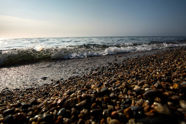 A beautiful rocky beach where waves are crashing energetically upon the shore, creating a picturesque coastal scene filled with nature