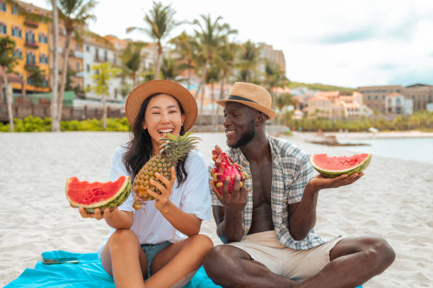 istock Interracial Couple Savoring Watermelon on Beach Holiday 2173988604