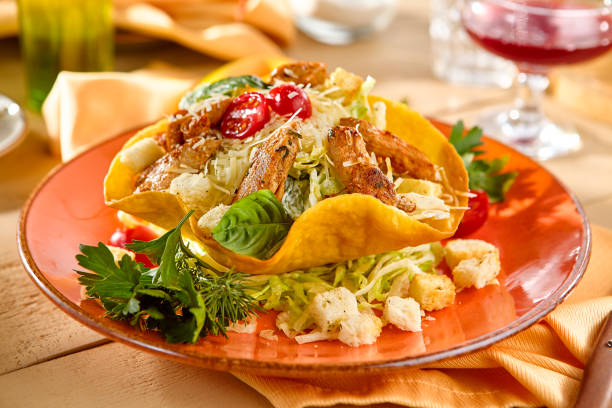 istock Fresh Caesar Salad in Tortilla Bowl with Grilled Chicken and Cherry Tomatoes 2173990210