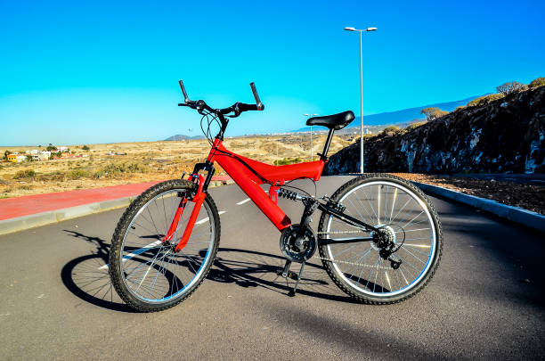 istock A red bicycle is parked on a road 2173994393