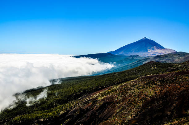 istock A mountain with a cloud of smoke rising from it 2173994646