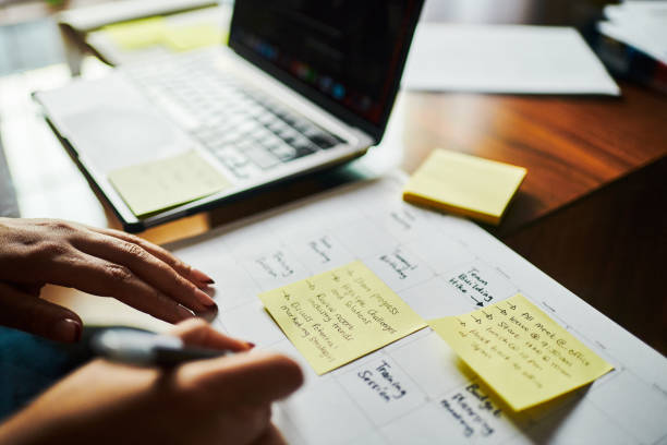 istock Focused Woman Working on Laptop with Yellow Sticky Notes 2173994762