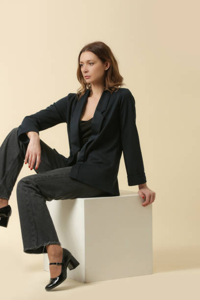 istock Female model wearing black shirt, jeans and dark blue blazer. Studio shoot. 2173995574