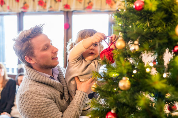 istock Happy family decorating christmas tree together 2173998214