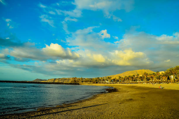 istock A beach with a clear blue sky and a few clouds 2173999912