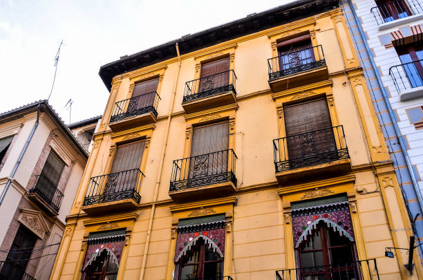 istock A yellow building with balconies and windows 2174000036