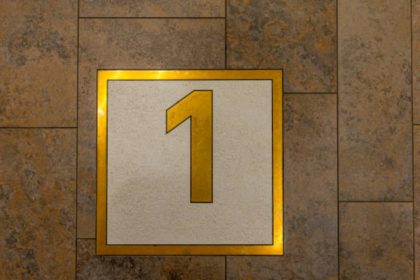 a gold and white square with the number 1 on it