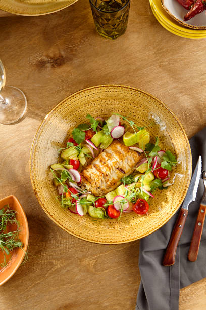 istock Colorful Sliced Pike Perch with Fresh Vegetable Salad on Rustic Ceramic Plate 2174000228