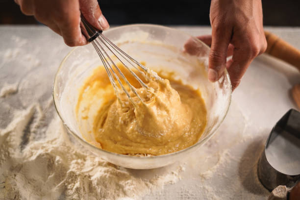 istock Pastry chef making dough with a whisk. cooking waffle on rustic wooden table with ingredients. Handmade dessert and cooking process 2174000421