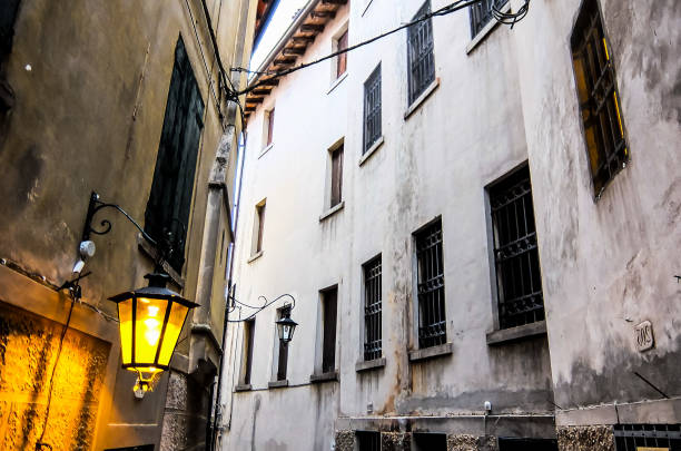 istock A narrow alleyway with a lamp post and a few windows 2174001395