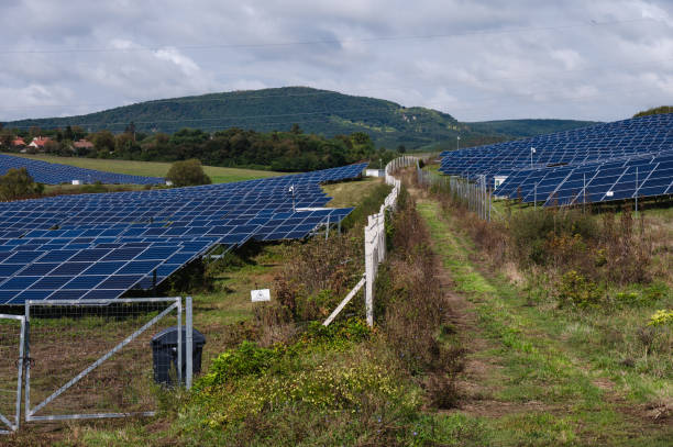 istock Solar panel farm in a rural landscape with blue sky 2174001669