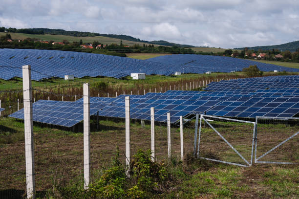 istock Solar panel farm in a rural landscape with blue sky 2174001680