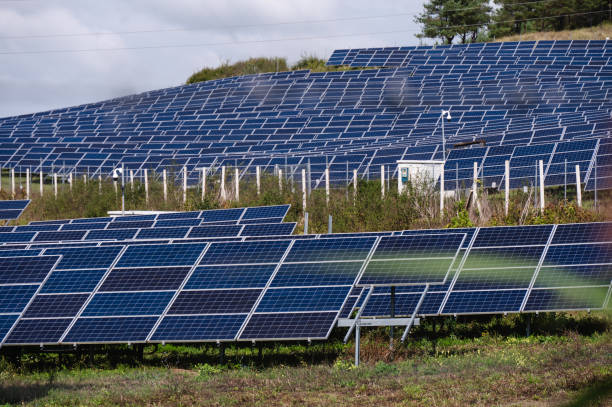 istock Solar panel farm in a rural landscape with blue sky 2174001689
