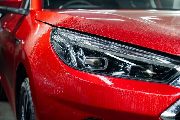 istock Close-up of a red car headlight with vinyl wrap. 2174005692