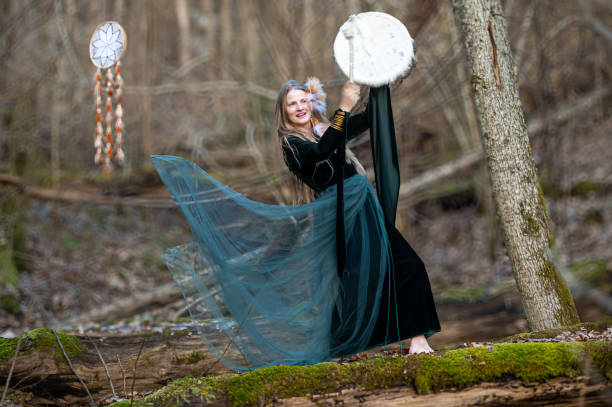 istock Woman playing a drum in a forest. Shallow depth of feld 2174008245