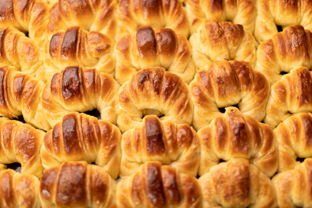 Top view of a tray of freshly baked croissants.