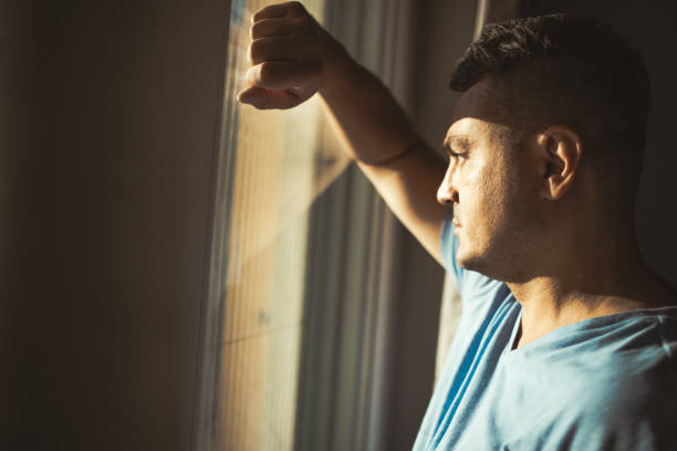 istock Man Looking Out of Window 2174022180