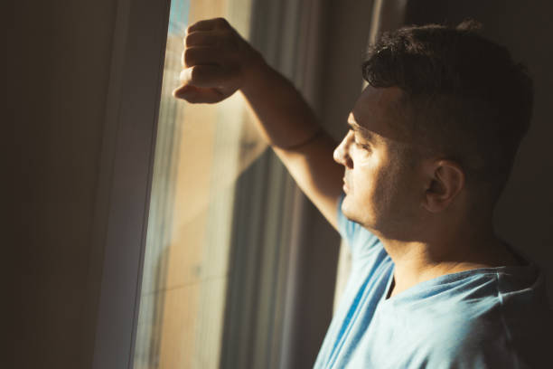 istock Man Looking Out of Window 2174022181