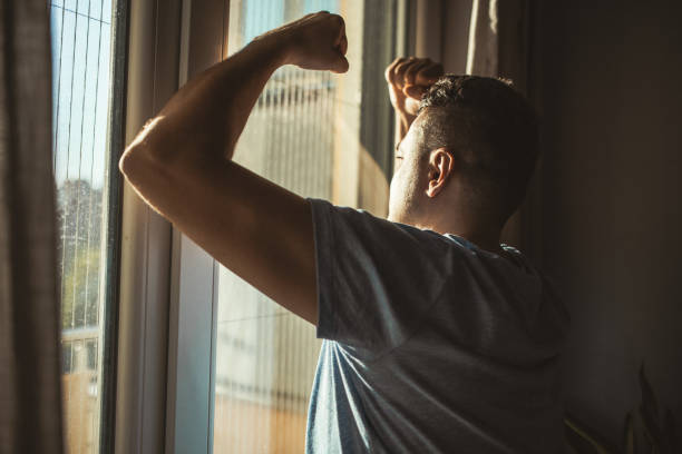 istock Man Looking Out of Window 2174022202