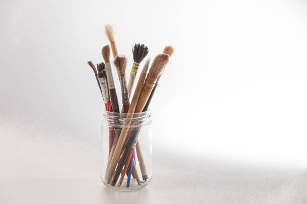 istock Artistic paintbrushes arranged in a glass jar on a bright surface during daylight hours, representing creativity in a studio environment 2174022905