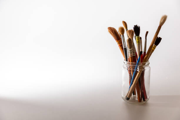 istock Artistic paintbrushes arranged in a glass jar on a bright surface during daylight hours, representing creativity in a studio environment 2174022944