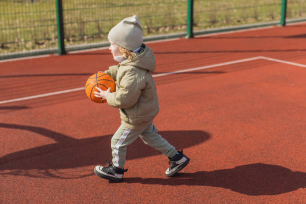 Child boy playing basketball