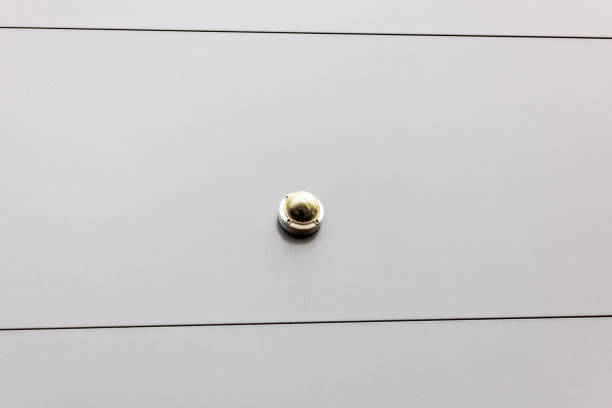 Close-up view of security camera mounted on modern exterior wall.