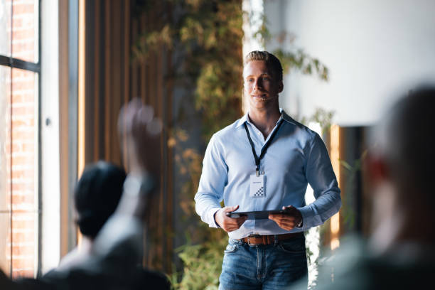Business Seminar Speaker Engaging with Audience in Modern Venue