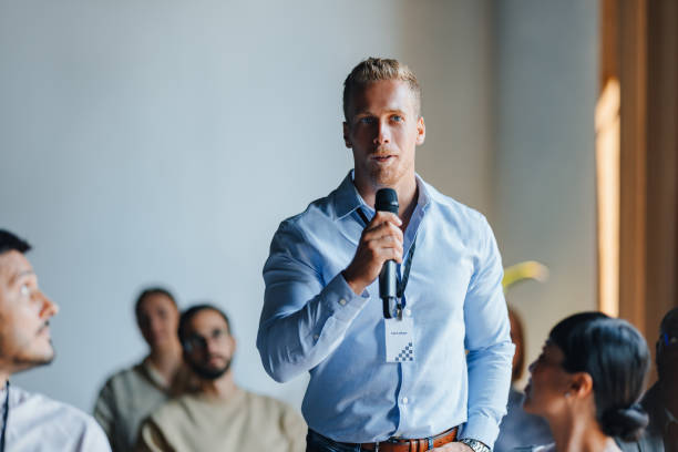 istock Confident Speaker Engaging Audience at a Business Meeting 2174029629