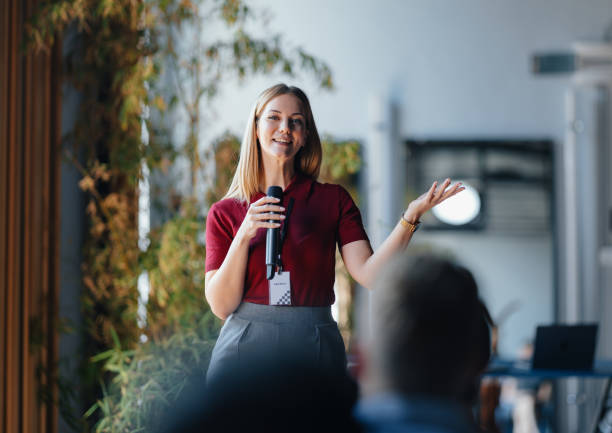istock Young Female Speaker Presenting at a Professional Event 2174029640