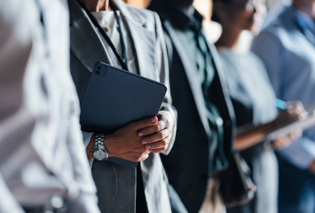 Professional Business Event with Group of People Holding Devices