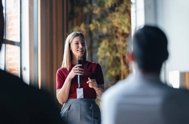 Confident Speaker Presenting to Engaged Audience at Business Event