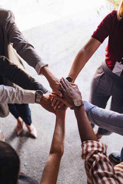 istock Diverse Group of Hands United in Teamwork Gesture 2174029676