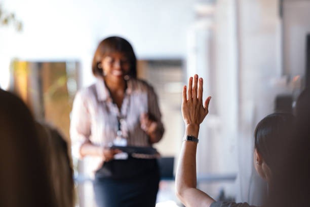 istock Engaged Audience Member Raising Hand During Meeting 2174029726